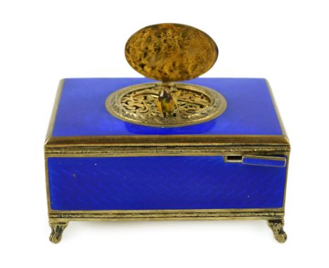 An early 20th century sterling silver gilt and blue guilloche enamelled rectangular singing bird box, on four cabriole feet, 