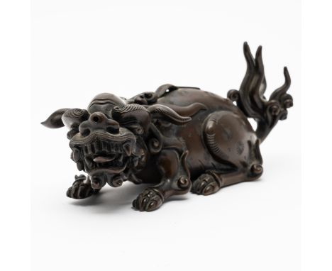 A CHINESE BRONZE WATER DROPPERPossibly late Ming dynasty Cast as a crouching Buddhist lion with apertures in its back and nos