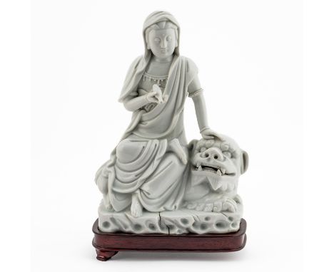 A CHINESE BLANC DE CHINE GROUP OF GUANYIN AND A LION (3)Potter's mark for Xu Youyi, 19th/20th century The goddess seated on t