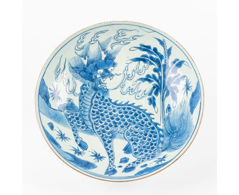 A LARGE CHINESE BLUE AND WHITE `QILIN' DEEP DISH17th century Painted with a fire breathing Qilin seated in a landscape beside