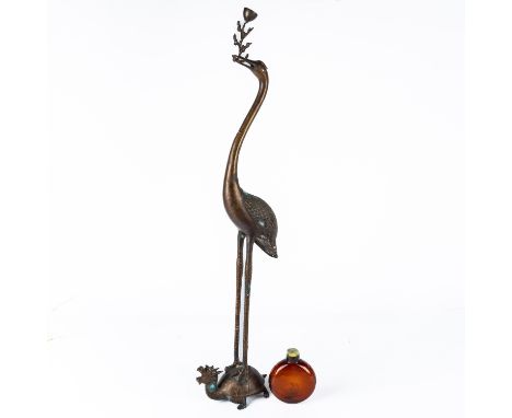 A JAPANESE PATINATED METAL `CRANE AND TURTLE' FORM CANDLESTICK (2)20th century 86cm high; also a large Chinese amber glass sn