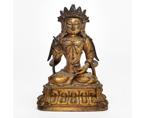 A CHINESE GILT-BRONZE FIGURE OF AMITAYUS18th/19th century Cast seated in padmasana on a lotus plinth, holding a stem in the r