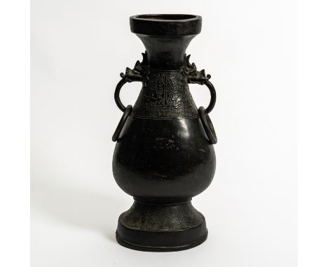 A TALL CHINESE BRONZE VASEYuan/Ming dynasty The flattened pear shaped body with a waisted neck decorated with a band of taoit