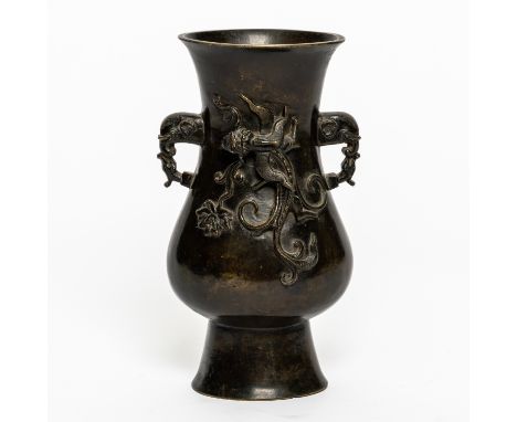 A CHINESE BRONZE TWO-HANDLED VASESix character Xuande mark but 17th/18th century Of flattened pear form set with elephant hea
