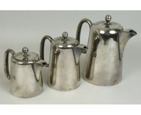 A NAAFI plated three piece service including lidded tea, coffee and milk jugs, the coffee jug, 18cm high, with embossed monog