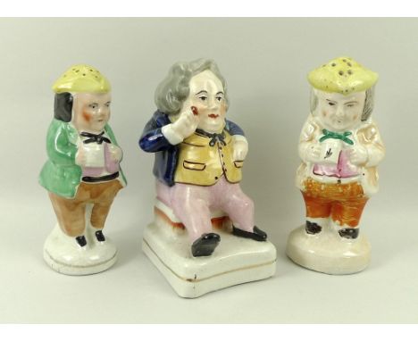 A Staffordshire ceramic figurine of a Dickens character, 14cm, and two Staffordshire Toby pepper shakers, circa 1850, 13 and 