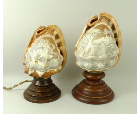 A pair of carved cowry shells, early 20th century, mounted on turned wooden bases, one depicting the view across the Bay of N