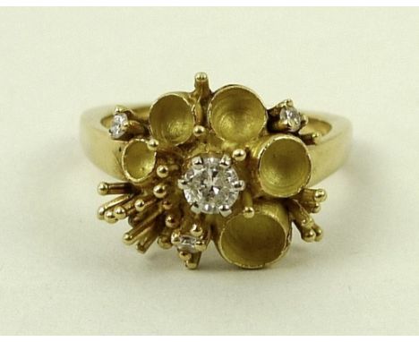 An 18ct gold, diamond and enamel dress ring, in the form of a buttercup, the central diamond of approximately 0.2ct, with thr