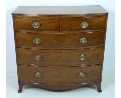 A Regency mahogany bow fronted chest of two over three graduating drawers, with cock beading and oval brass plate handles, sh