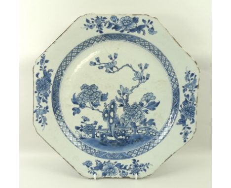 A Chinese ceramic hexagonal dish, 18th century, in blue and white and decorated with peonies, 36cm high.
