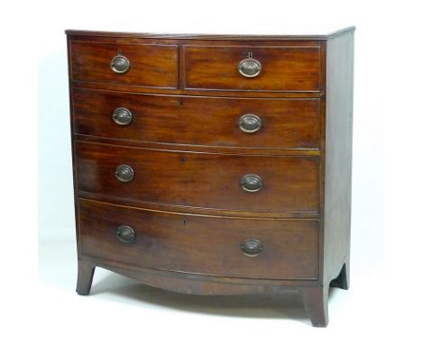 A Regency mahogany chest of two short over three long graduating drawers, with cock beading and pressed brass oval plate hand