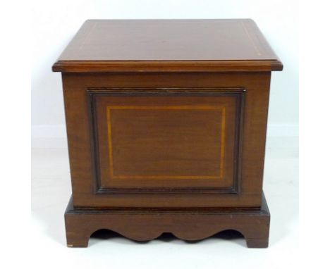 A Edwardian mahogany and crossbanded commode, lift lid revealing a white ceramic bowl and lid, raised on shaped plinth base, 