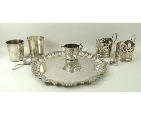 A collection of silver and plated wares including a pair of toddy glass holders, a silver plated salver, 28cm, a jug, the swi