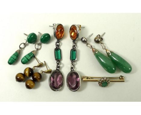 A collection of drop earrings comprising jade, tiger's eye, and cairngorm and green stone, and a diamond and emerald brooch. 