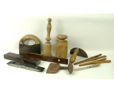 A collection of treen comprising a herb chopper, work tools, glove stretcher, and butter knife, together with three spirit le