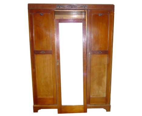 A late Edwardian compactum, three doors, central mirrored, with hanging space on one side, three slides and two drawers/hat b