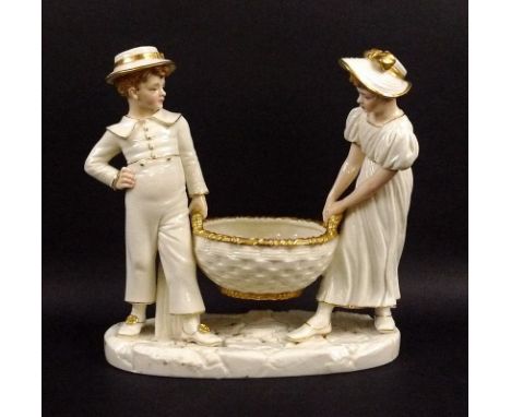 A Royal Worcester ivory porcelain figural group, of a girl and boy holding a basket, with gilded highlights, impressed and gr