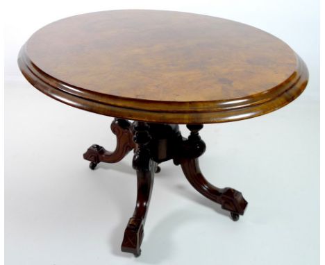 A Victorian burr walnut loo table, with oval tilt top burr walnut surface, deeply moulded edge, raised on a pedestal base wit