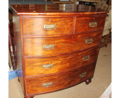 A late 19th century mahogany bowfront chest of two short and three long drawers with Aesthetic Movement brass handles, on tur