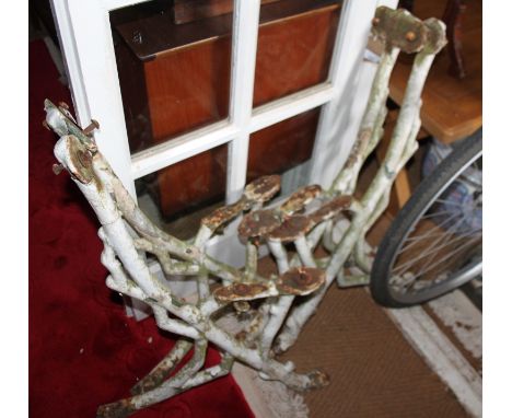 A pair of cast iron bench ends of naturalistic form 