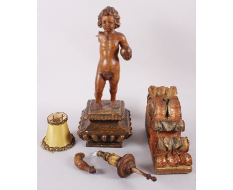 An early 18th century Continental carved wood bracket with figure of Christ child holding a globe, 28" high (damages) 