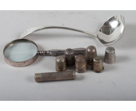 A silver sauce ladle, 1.9oz troy approx, six silver thimbles, a silver pill box, 1.1oz troy approx and a silver mounted magni