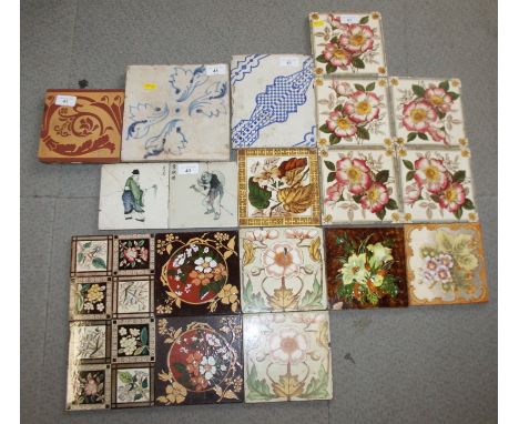 An 18th century Delft blue and white floral decorated tile, an Intarsia tile and a quantity of other ceramic tiles 