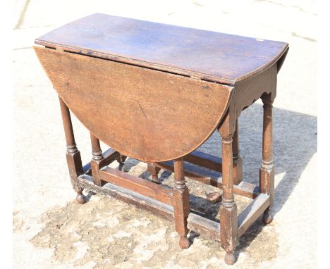 An 18th century oak provincial drop leaf occasional table, on turned and stretchered gate leg support, 34" wide x 40 1/2" dee