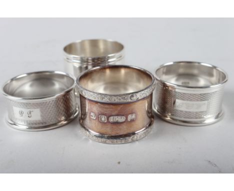 A presentation silver napkin ring, 1.3oz troy approx, two engine turned silver napkin rings, 0.7oz troy approx, and a silver 