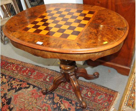 A Wilkinson and Son patent 19th century figured walnut and inlaid oval games table with reversible top revealing bagatelle ga