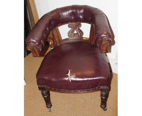 An early Victorian carved walnut library chair with pierced splat back, button upholstered in a leather cloth, on turned supp