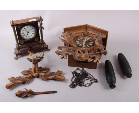 A French mahogany and brass mantel clock with white painted dial and Roman numerals, and a Schatz eight-day cuckoo clock 