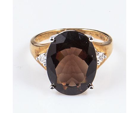 A 9ct gold lady's 4.4gm ring set with diamonds and 7ct smoky topaz