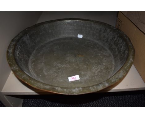A large copper basin with twin handles
