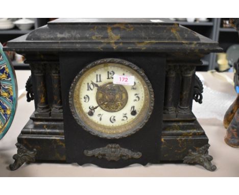 A Victorian gothic cased mantle clock having an enamel and ormolu face