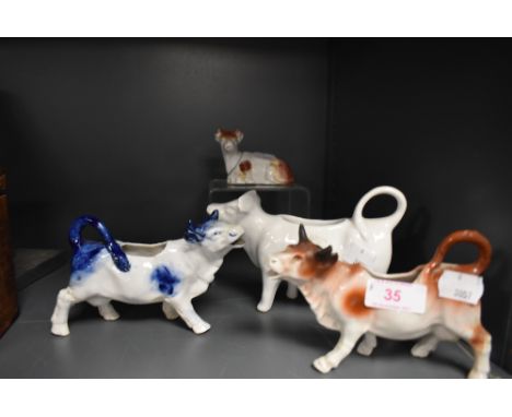 A selection of ceramic cow style creamers or milk jugs