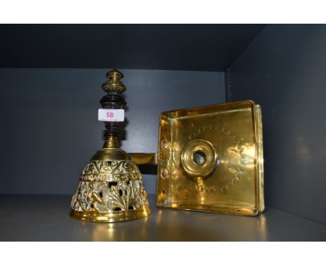 An antique brass square form chamber stick and an ornate dinner bell