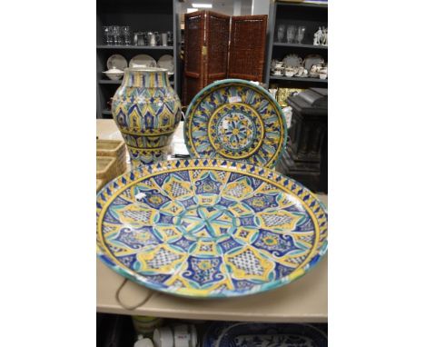 Three ceramic pieces hand decorated in Portuguese designs a large charger, wall plaque and vase