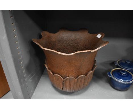 A heavy cast iron planter top in the form of a lotus flower and leaf
