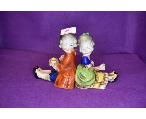 A pair of ceramic book ends possibly German having stamp to base