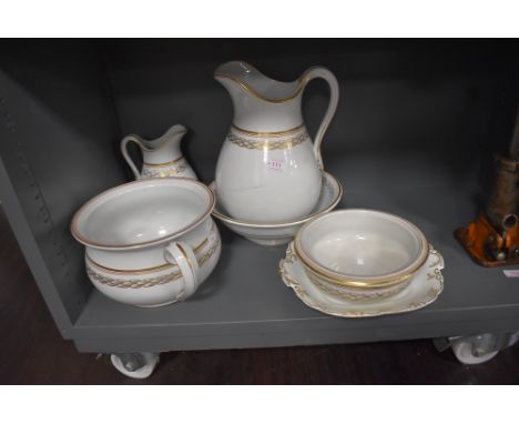 An Ashworth wash jug a bowl vanity set in gilt and white ground