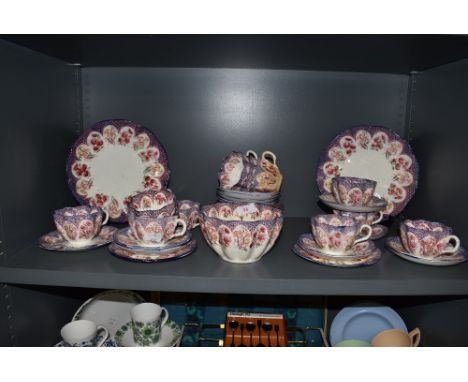 A late Victorian part tea service in pink and purple hues Reg no. 206146