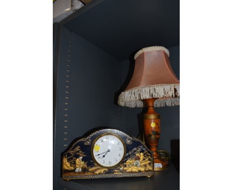 An art deco chinoiserie styled mantle clock well detailed with a similar matching table lamp