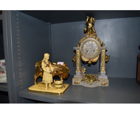 A ceramic figure study by Eichwald and a stone and ormolu mantle clock