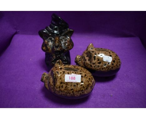 Three ceramic money banks including to piggy banks and a fox with hat