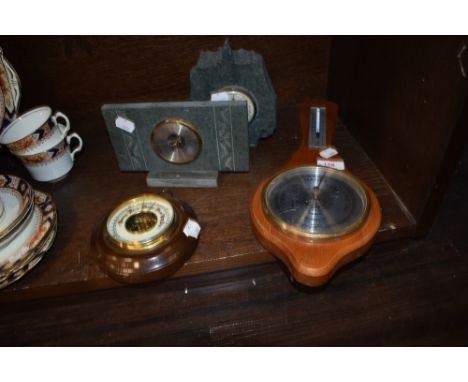 Four vintage barometers including slate mantel examples.