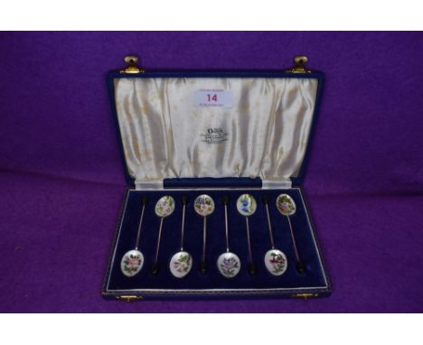 A cased set of eight Hm silver tea spoons being decorated with fine enamel work of garden flowers retailed by Ogden Harrogate