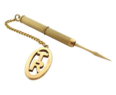 Gold engine turned toothpick hallmarked 9ct, with gold 'TR' fob and chain stamped 9ct - Condition Report Approx 11.4gm