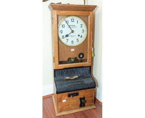 A good National Time Recorder Ltd industrial time recorder/ clocking in clock in oak case, 14" x 35" x 11", with 9-inch dial.