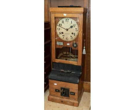 A National Time Recorder industrial wall-mounted time recorder/ clocking-in clock in an oak case, 13" x 39" x 11" with a draw
